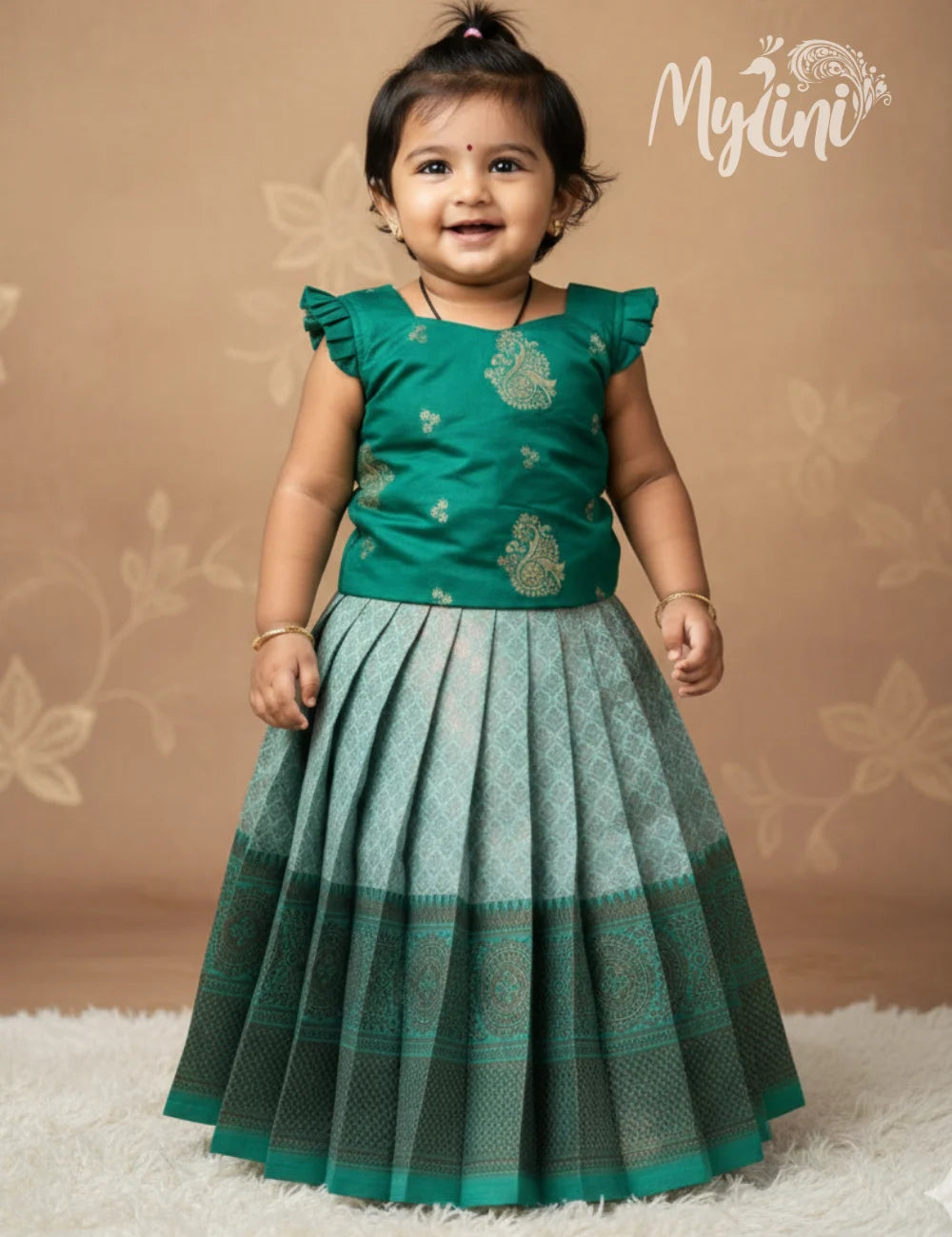Child wearing a green traditional outfit with a brown background