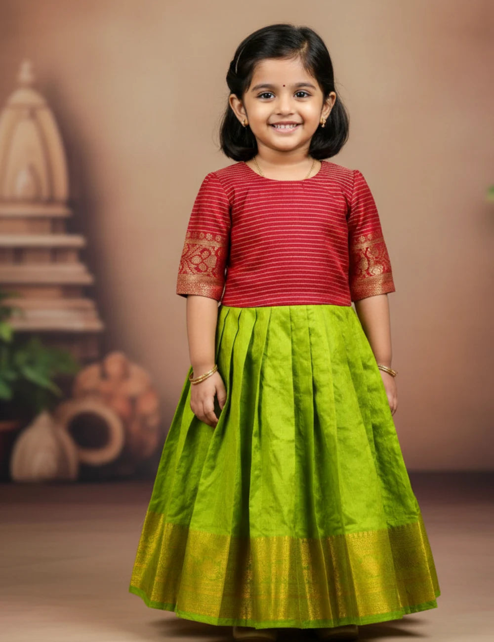 Young girl wearing a red top and green skirt against a brown background